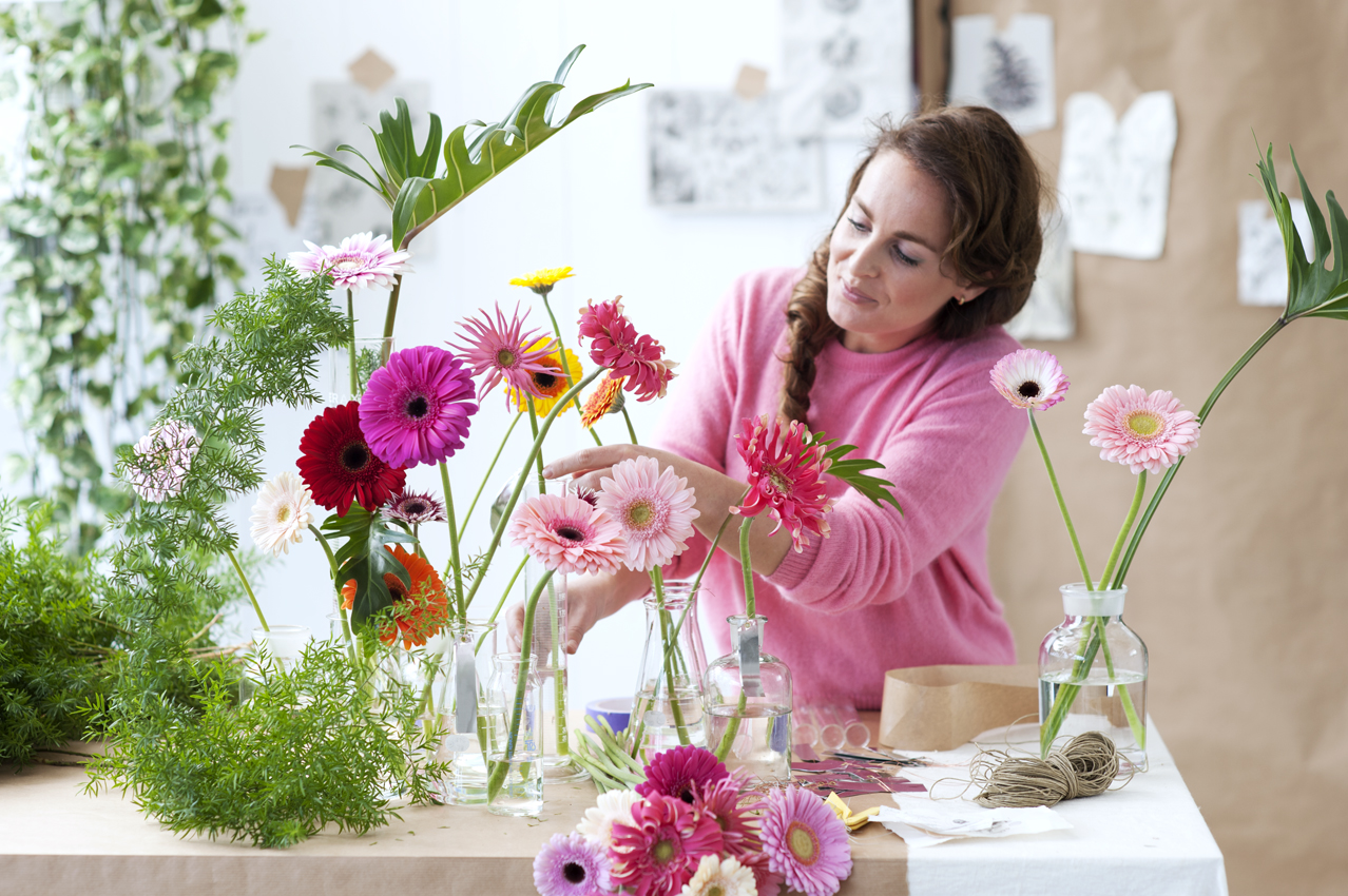 Woman arranging flowers on a vase