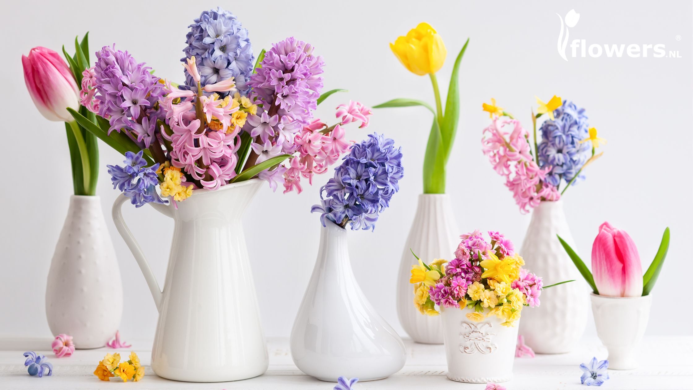 Assorted Spring flowers in small vases.